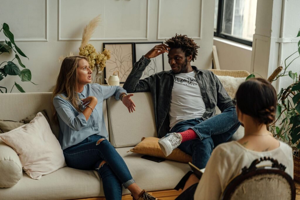 A couple is engaged in a lively conversation during a therapy session with a counselor