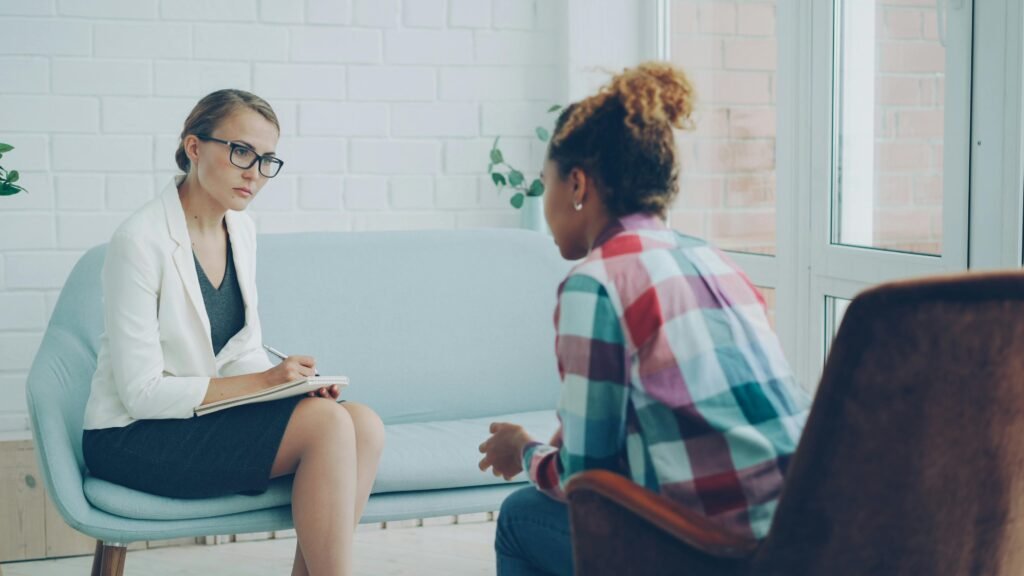 A therapist listens attentively during a private counseling session